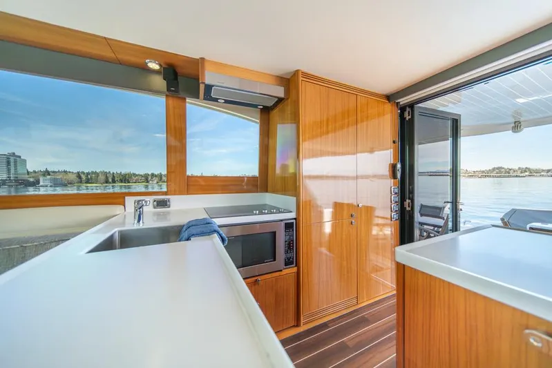Escape Yacht Photos Pics Interior of 2013 Maritimo M58 yacht with modern kitchen and scenic water view.