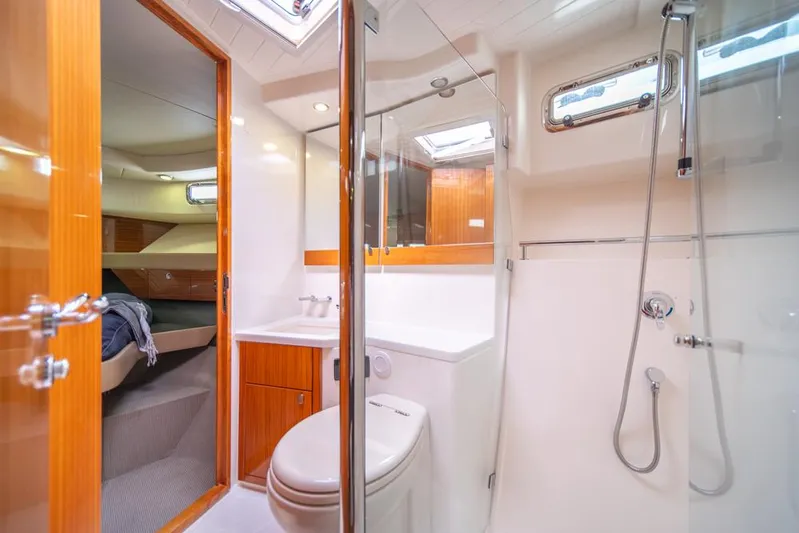 Escape Yacht Photos Pics Luxurious bathroom in 2013 Maritimo M58 yacht with shower, toilet, and wooden accents.