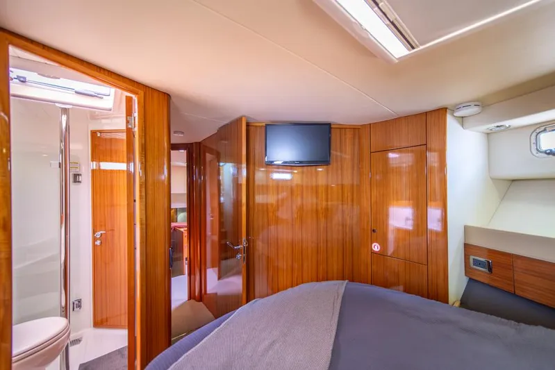 Escape Yacht Photos Pics Luxurious cabin interior of 2013 Maritimo M58 yacht with wood paneling and modern amenities.