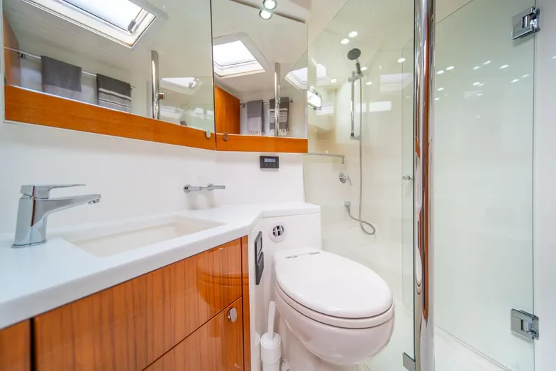 Escape Yacht Photos Pics Luxurious Maritimo M58 2013 yacht bathroom with modern fixtures and wooden cabinetry.