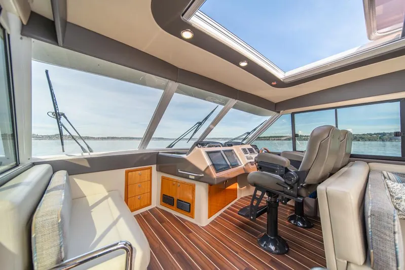 Escape Yacht Photos Pics Luxurious interior of 2013 Maritimo M58 yacht with panoramic windows and plush seating.