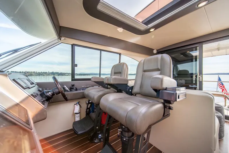 Escape Yacht Photos Pics Interior of 2013 Maritimo M58 yacht with modern helm and seating.