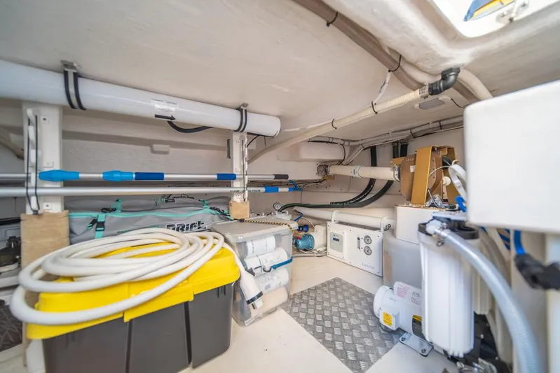 Escape Yacht Photos Pics Engine room of 2013 Maritimo M58 yacht with organized equipment and storage.