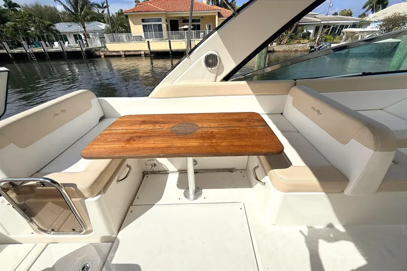 Sweet Melissa Yacht Photos Pics 2013 Sea Ray 370 Venture boat interior with wooden table and cushioned seating.
