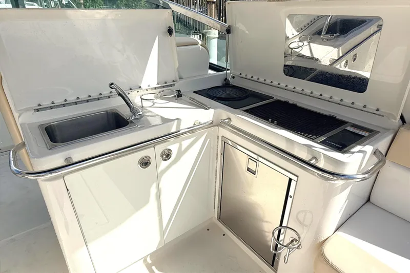 Sweet Melissa Yacht Photos Pics 2013 Sea Ray 370 Venture boat kitchenette with sink, grill, and storage.