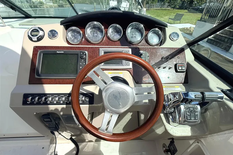 Sweet Melissa Yacht Photos Pics Cockpit of 2013 Sea Ray 370 Venture with steering wheel and control panel.