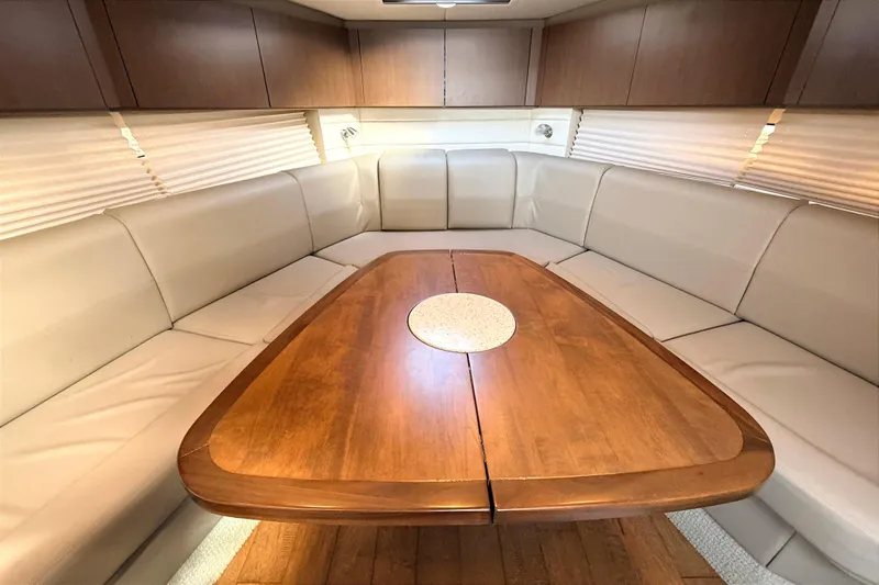 Sweet Melissa Yacht Photos Pics Luxurious interior of 2013 Sea Ray 370 Venture yacht with elegant wood table and plush seating.