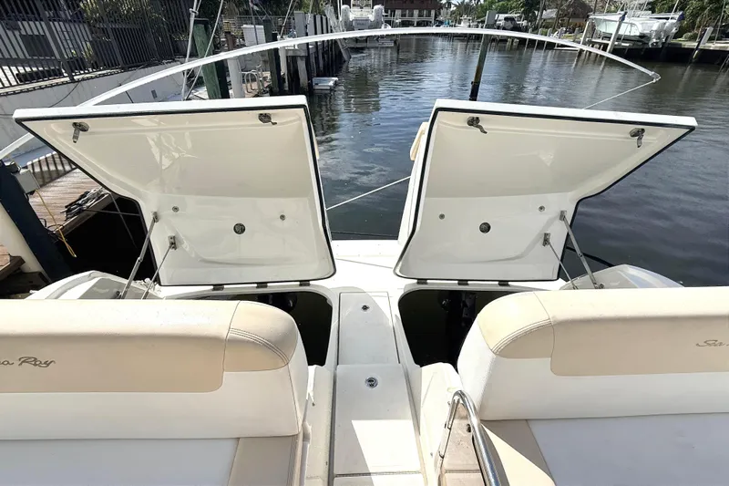 Sweet Melissa Yacht Photos Pics 2013 Sea Ray 370 Venture boat with open storage compartments, docked by the water.