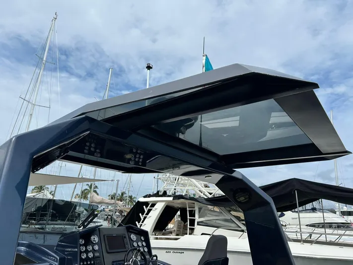 Quoq Yacht Photos Pics 2016 Maori 50 yacht helm with modern design, docked at marina under cloudy sky.