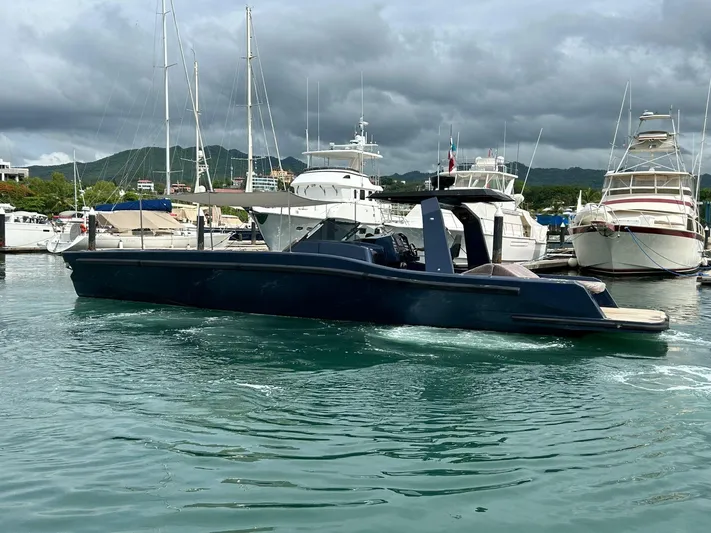 Quoq Yacht Photos Pics 2016 Maori 50 yacht docked in a marina with other boats, under cloudy skies.