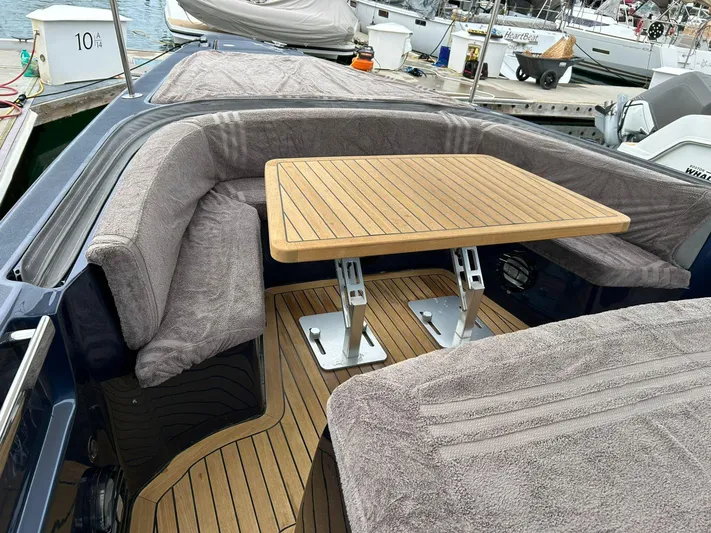 Quoq Yacht Photos Pics Luxurious 2016 Maori 50 yacht interior with cushioned seating and wooden table at marina.