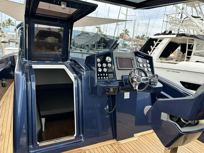 Quoq Yacht Photos Pics Cockpit of a 2016 Maori 50 yacht with modern navigation controls and wooden deck.