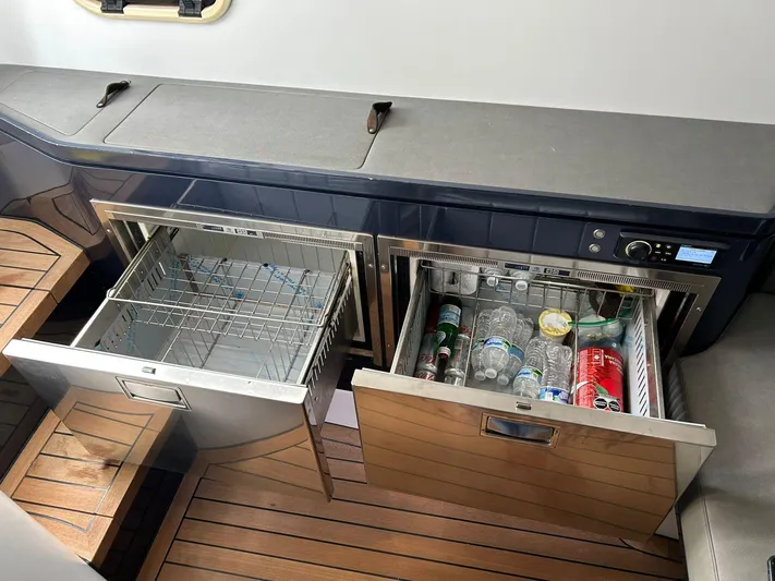 Quoq Yacht Photos Pics Built-in drawers on a Maori 50 yacht, one open with drinks, the other empty.