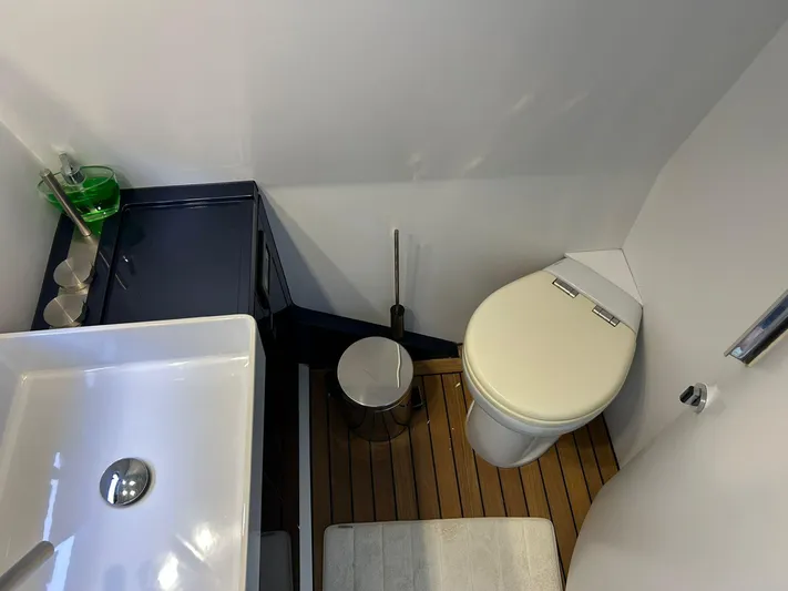 Quoq Yacht Photos Pics Compact bathroom in a 2016 Maori 50 yacht, featuring a sink, toilet, and wooden flooring.