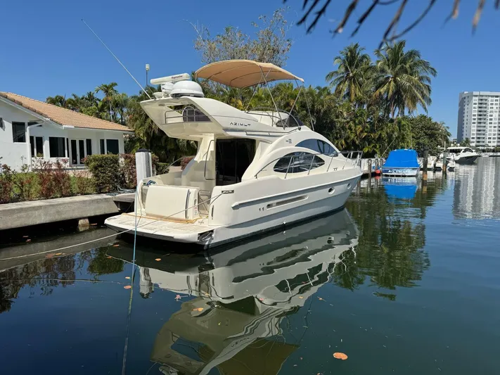 Weekender 3 Yacht Photos Pics 2005 Azimut 42 Fly yacht docked in a serene marina setting.
