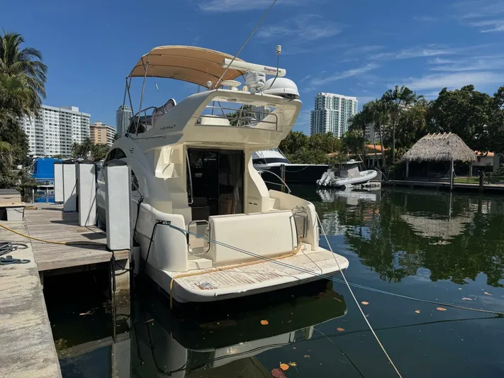 Weekender 3 Yacht Photos Pics 2005 Azimut 42 Fly yacht docked in a marina, surrounded by water and buildings.
