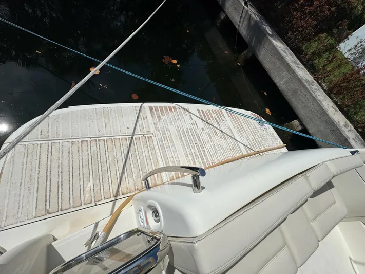 Weekender 3 Yacht Photos Pics 2005 Azimut 42 Fly yacht deck with seating, docked by the water.