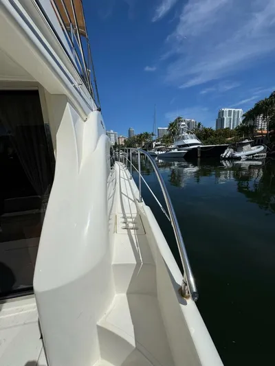 Weekender 3 Yacht Photos Pics Azimut 42 Fly 2005 yacht docked in a marina, clear blue sky, waterfront view.