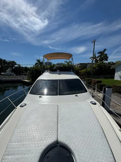 Weekender 3 Yacht Photos Pics 2005 Azimut 42 Fly yacht docked, featuring sleek design and spacious flybridge under a clear sky.