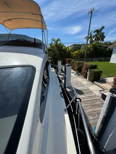 Weekender 3 Yacht Photos Pics 2005 Azimut 42 Fly yacht docked, showcasing sleek design and sunny surroundings.