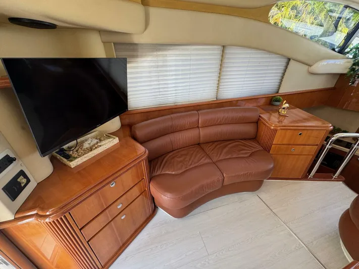 Weekender 3 Yacht Photos Pics Luxurious interior of 2005 Azimut 42 Fly yacht with leather sofa and TV.