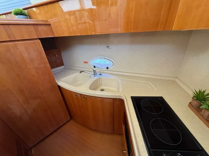 Weekender 3 Yacht Photos Pics Luxurious kitchen area in a 2005 Azimut 42 Fly yacht with modern amenities.