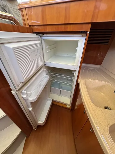Weekender 3 Yacht Photos Pics 2005 Azimut 42 Fly yacht kitchen with open fridge and sink.