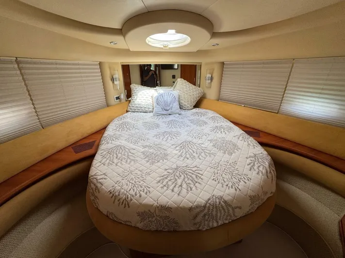 Weekender 3 Yacht Photos Pics Luxurious bedroom interior of 2005 Azimut 42 Fly yacht with elegant bedding.
