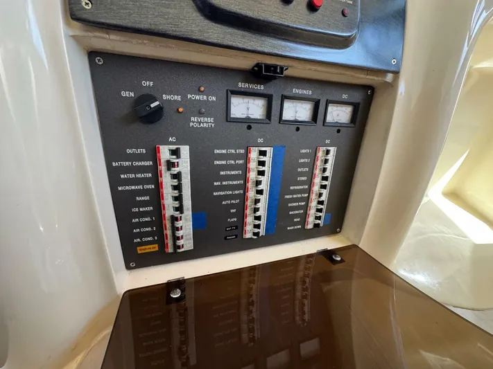 Weekender 3 Yacht Photos Pics Electrical control panel on a 2005 Azimut 42 Fly yacht, featuring various switches and meters.