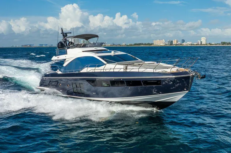  Yacht Photos Pics Luxury 2019 Azimut S7 yacht cruising on open water, city skyline in background.