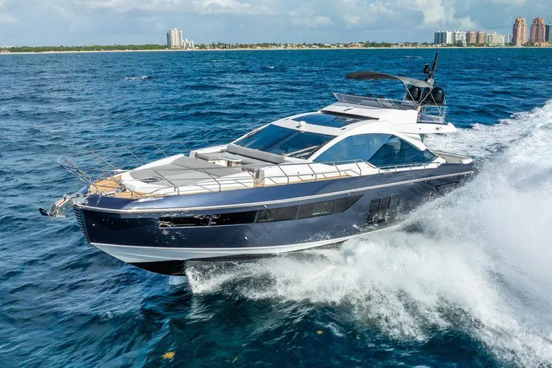  Yacht Photos Pics 2019 Azimut S7 yacht cruising on open water, city skyline in background.