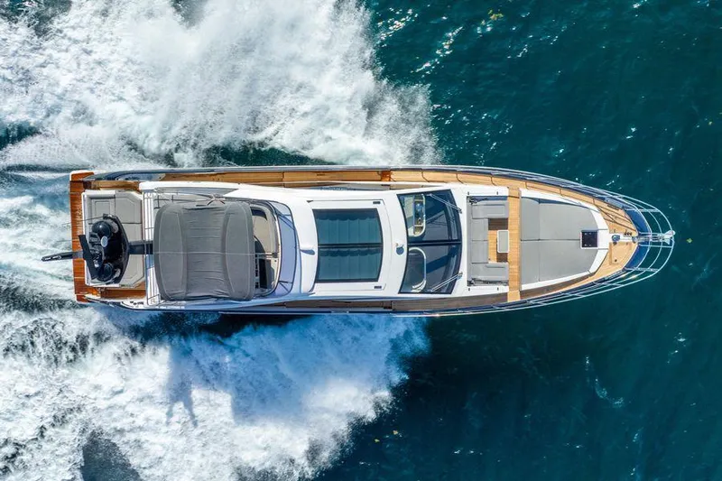  Yacht Photos Pics Aerial view of 2019 Azimut S7 yacht cruising on blue ocean waters.