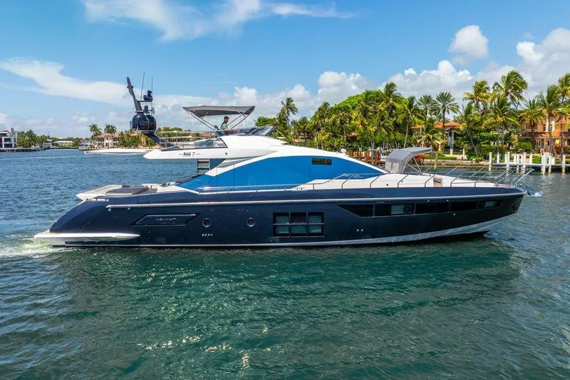  Yacht Photos Pics 2019 Azimut S7 yacht cruising on a sunny day near palm-lined shore.