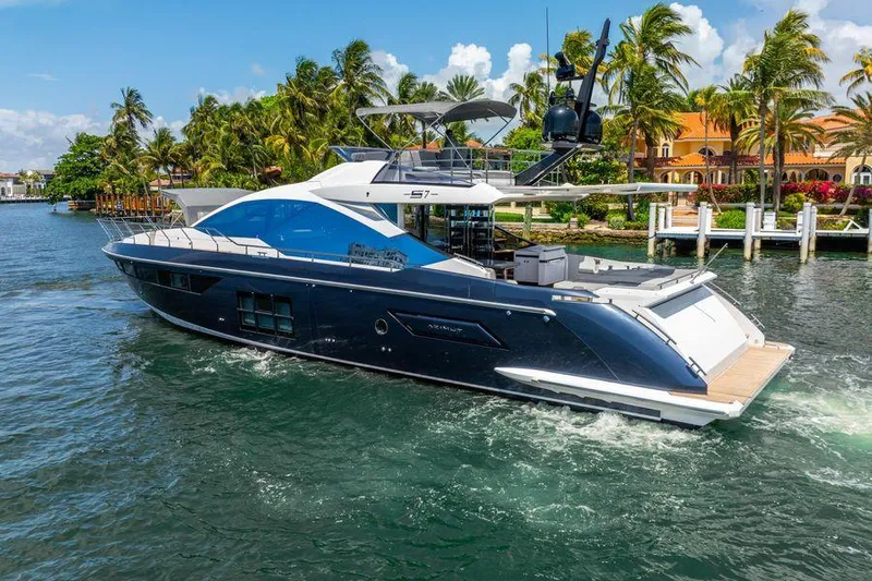  Yacht Photos Pics Luxurious 2019 Azimut S7 yacht cruising in tropical waters with palm trees in the background.