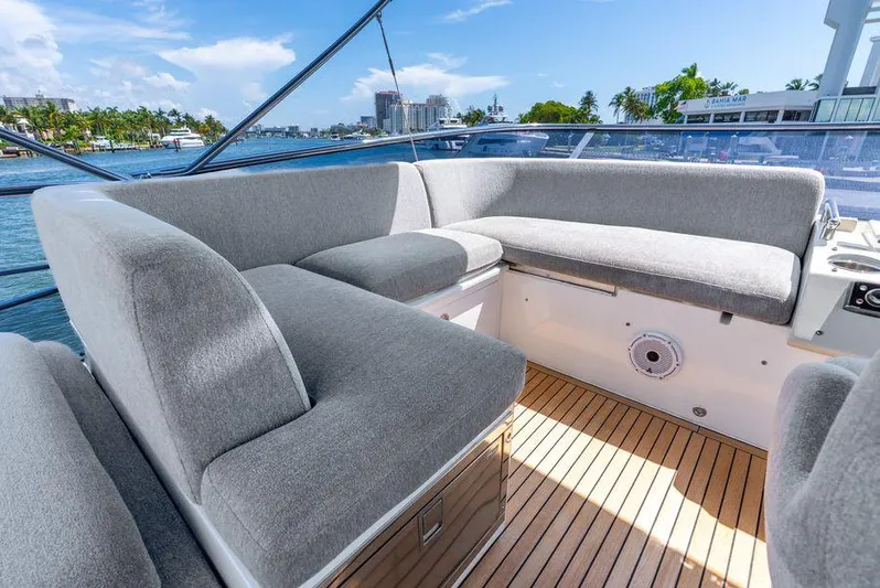  Yacht Photos Pics Luxurious seating area on 2019 Azimut S7 yacht with gray cushions and wooden deck.