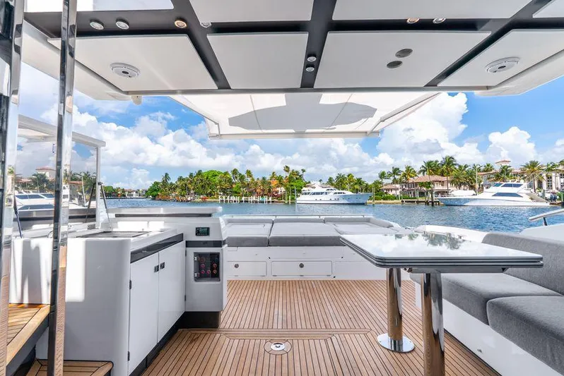  Yacht Photos Pics Luxurious 2019 Azimut S7 yacht deck with seating, table, and scenic waterfront view.