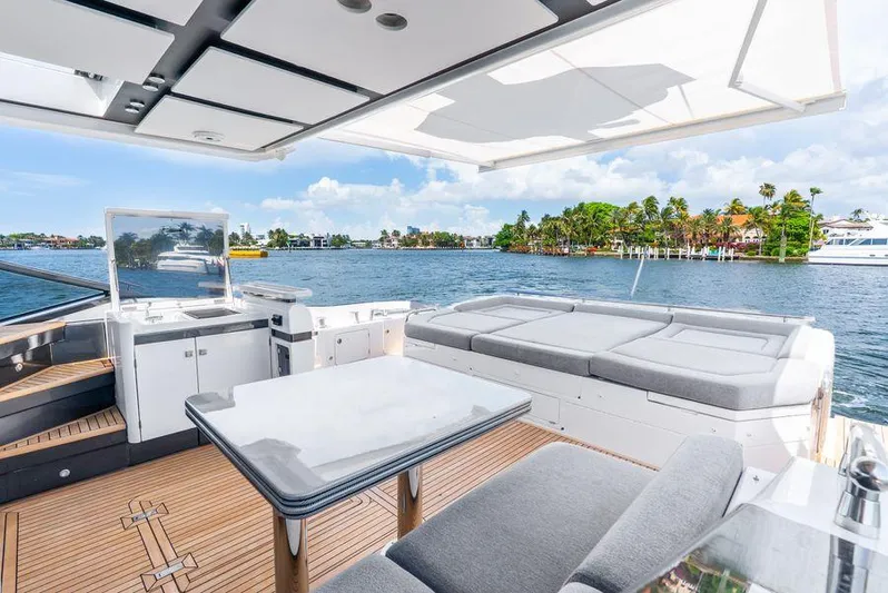  Yacht Photos Pics Luxurious 2019 Azimut S7 yacht deck with seating, table, and scenic waterfront view.