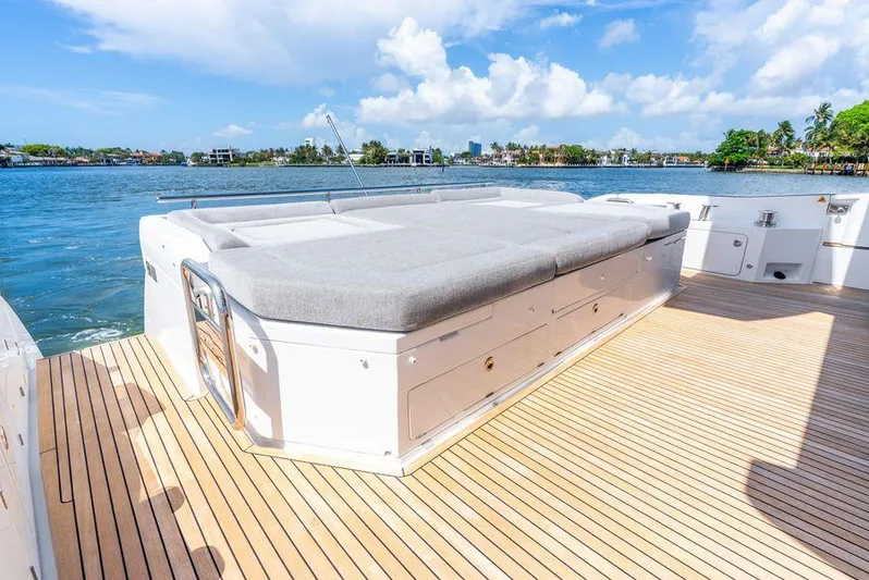  Yacht Photos Pics Luxurious 2019 Azimut S7 yacht deck with sunbed, overlooking serene waters and blue sky.