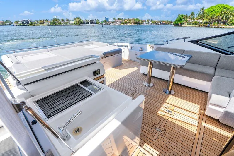 Yacht Photos Pics Luxurious 2019 Azimut S7 yacht deck with seating, table, and sink, overlooking serene waters.