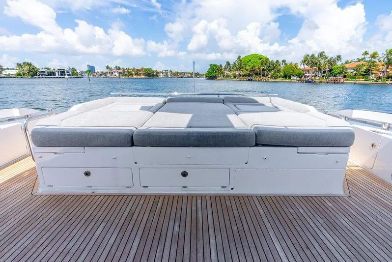  Yacht Photos Pics Luxurious 2019 Azimut S7 yacht deck with sunbed, overlooking serene waterfront scenery.