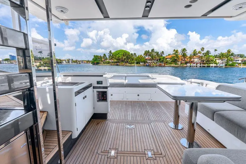  Yacht Photos Pics Luxurious 2019 Azimut S7 yacht deck with seating, table, and scenic waterfront view.