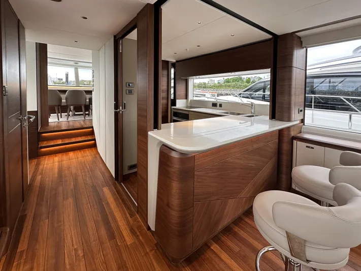 X80034 Yacht Photos Pics Luxurious interior of 2024 Princess X80 yacht with modern wood finishes and elegant seating.