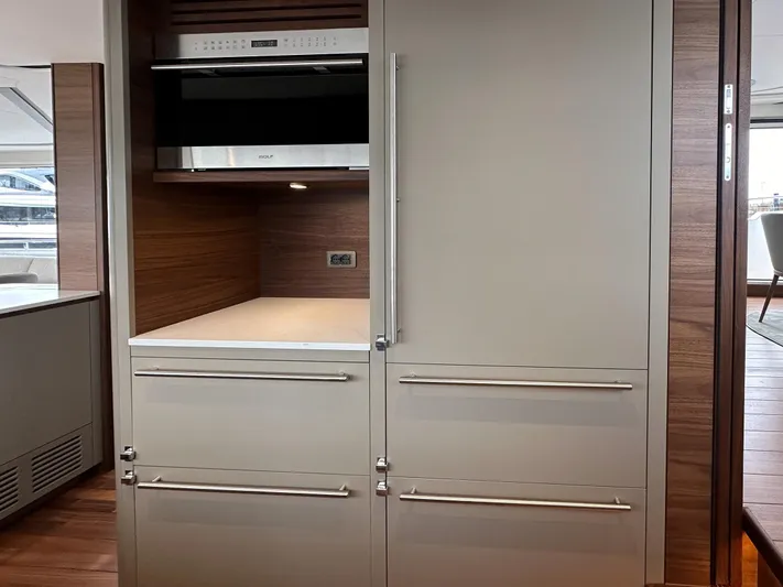 X80034 Yacht Photos Pics Modern kitchen area in 2024 Princess X80 yacht with sleek cabinetry and built-in appliances.