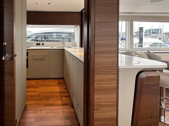 X80034 Yacht Photos Pics Luxurious interior of 2024 Princess X80 yacht with modern kitchen and wooden flooring.