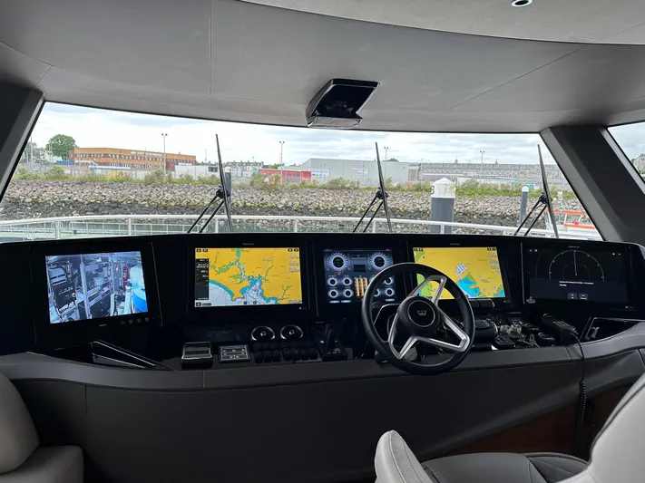 X80034 Yacht Photos Pics Control panel of 2024 Princess X80 yacht with advanced navigation displays and steering wheel.