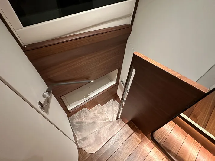 X80034 Yacht Photos Pics Interior of 2024 Princess X80 yacht, featuring elegant wooden stairs and modern design.