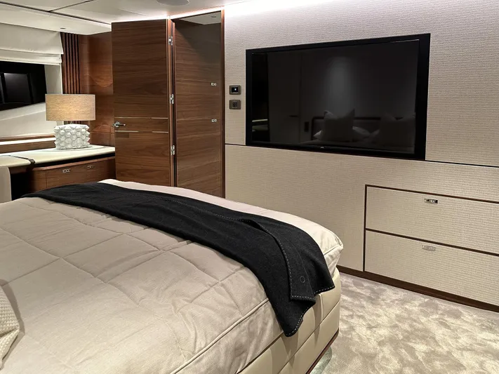 X80034 Yacht Photos Pics Luxurious bedroom interior of 2024 Princess X80 yacht with modern decor and large TV.