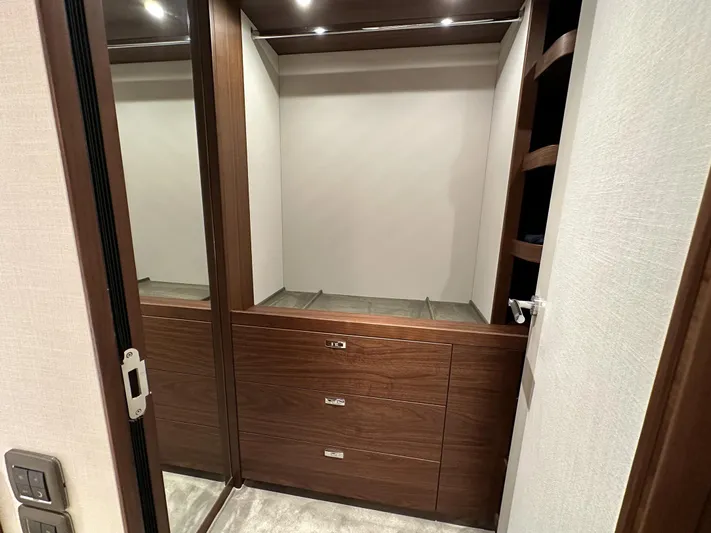 X80034 Yacht Photos Pics Luxurious wooden closet interior in 2024 Princess X80 yacht, featuring sleek design and ample storage.
