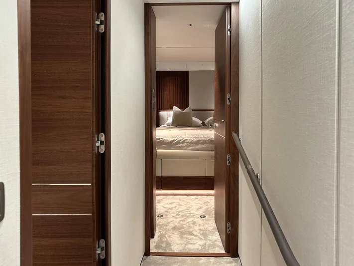 X80034 Yacht Photos Pics Luxurious interior hallway leading to a bedroom on the 2024 Princess X80 yacht.