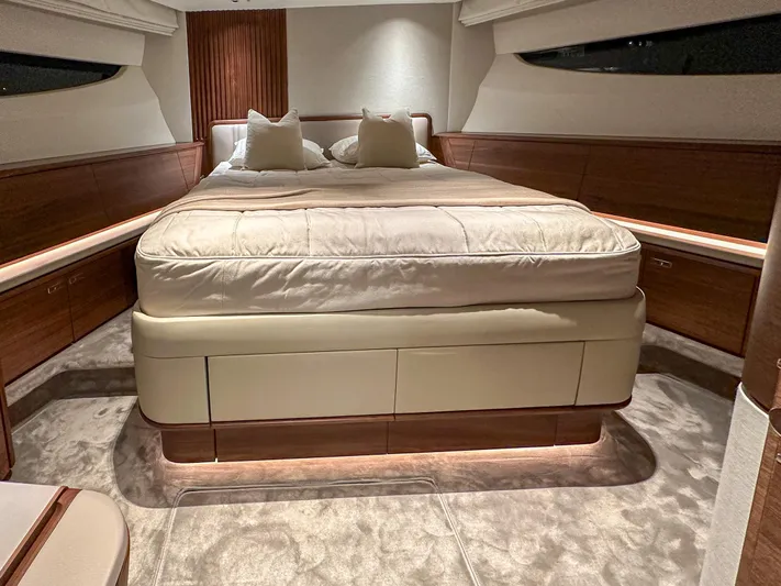 X80034 Yacht Photos Pics Luxurious bedroom interior of 2024 Princess X80 yacht with elegant bedding and wood accents.